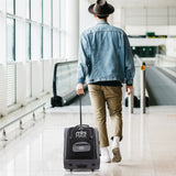 Traveler with Aerolite MiniMAX trolley backpack at airport
