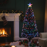 Decorated Christmas tree with colorful lights in a living room with a fireplace and stockings.