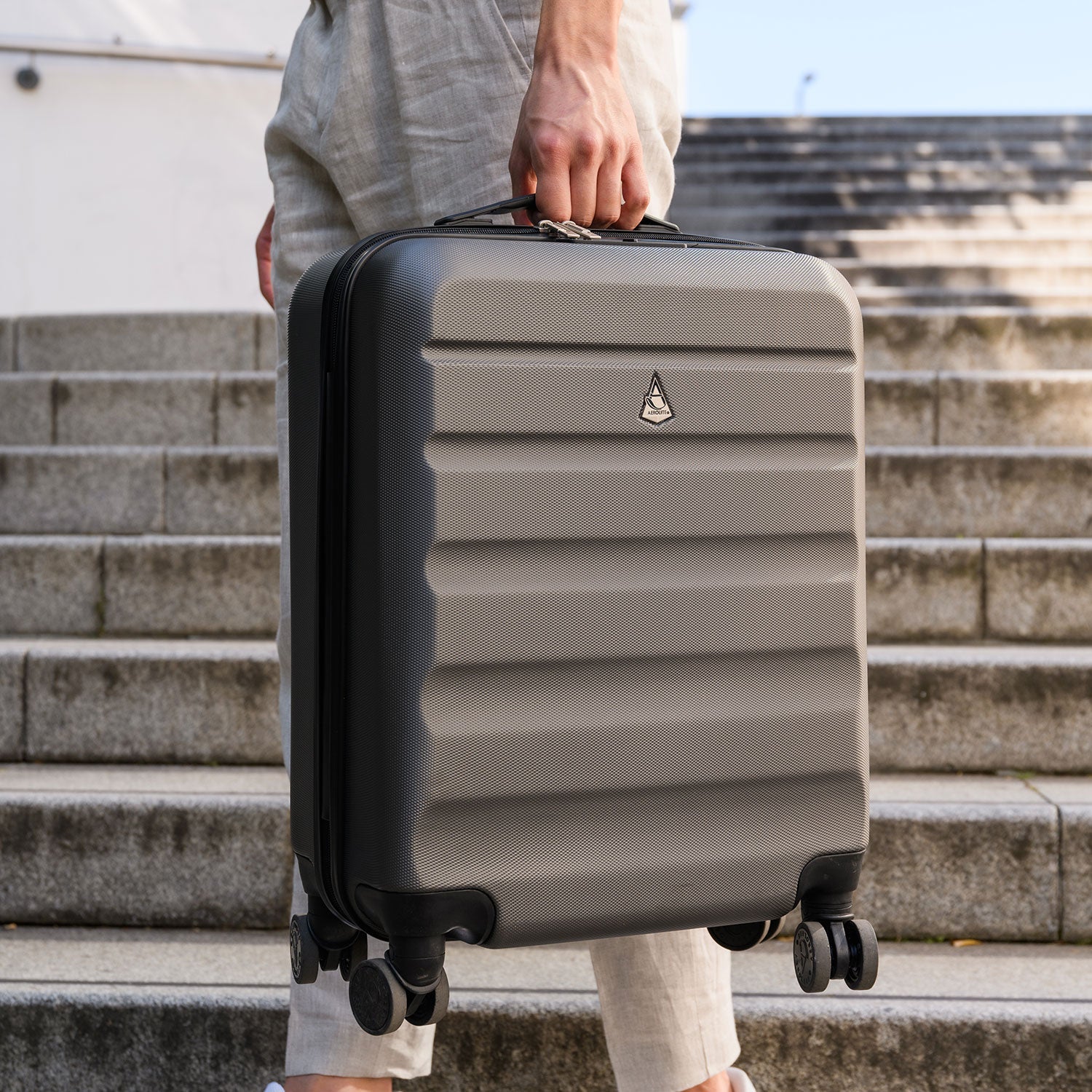Man holding Aerolite suitcase on stairs